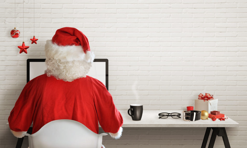Santa Claus responds to letters on a computer for Christmas